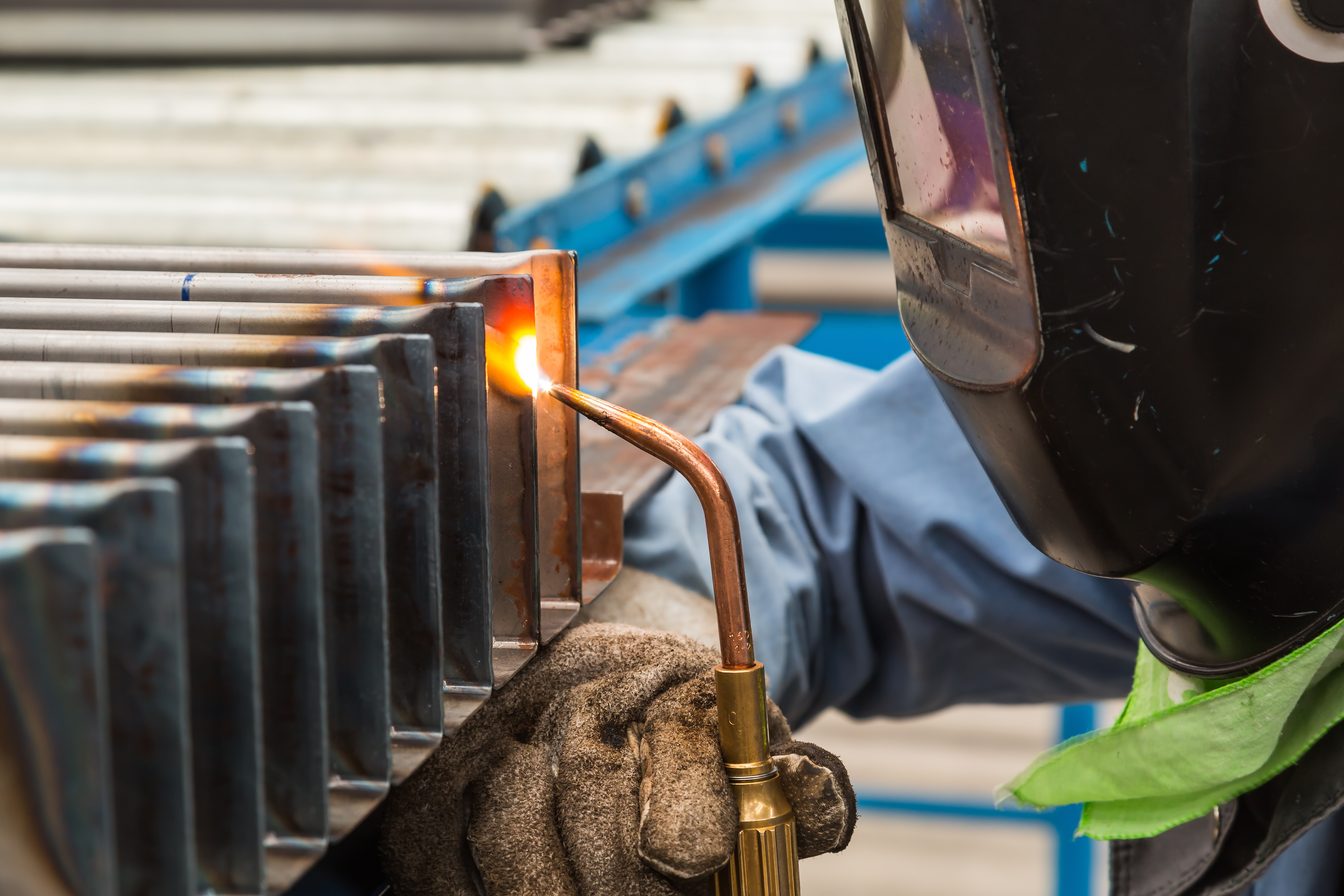 Man Welding On A Column Metal Sheets